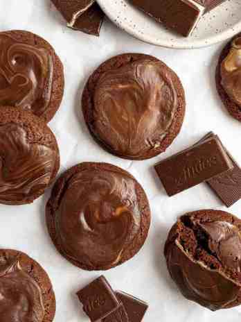 An overhead view of several Andes mint cookies spread out on a piece of parchment paper.