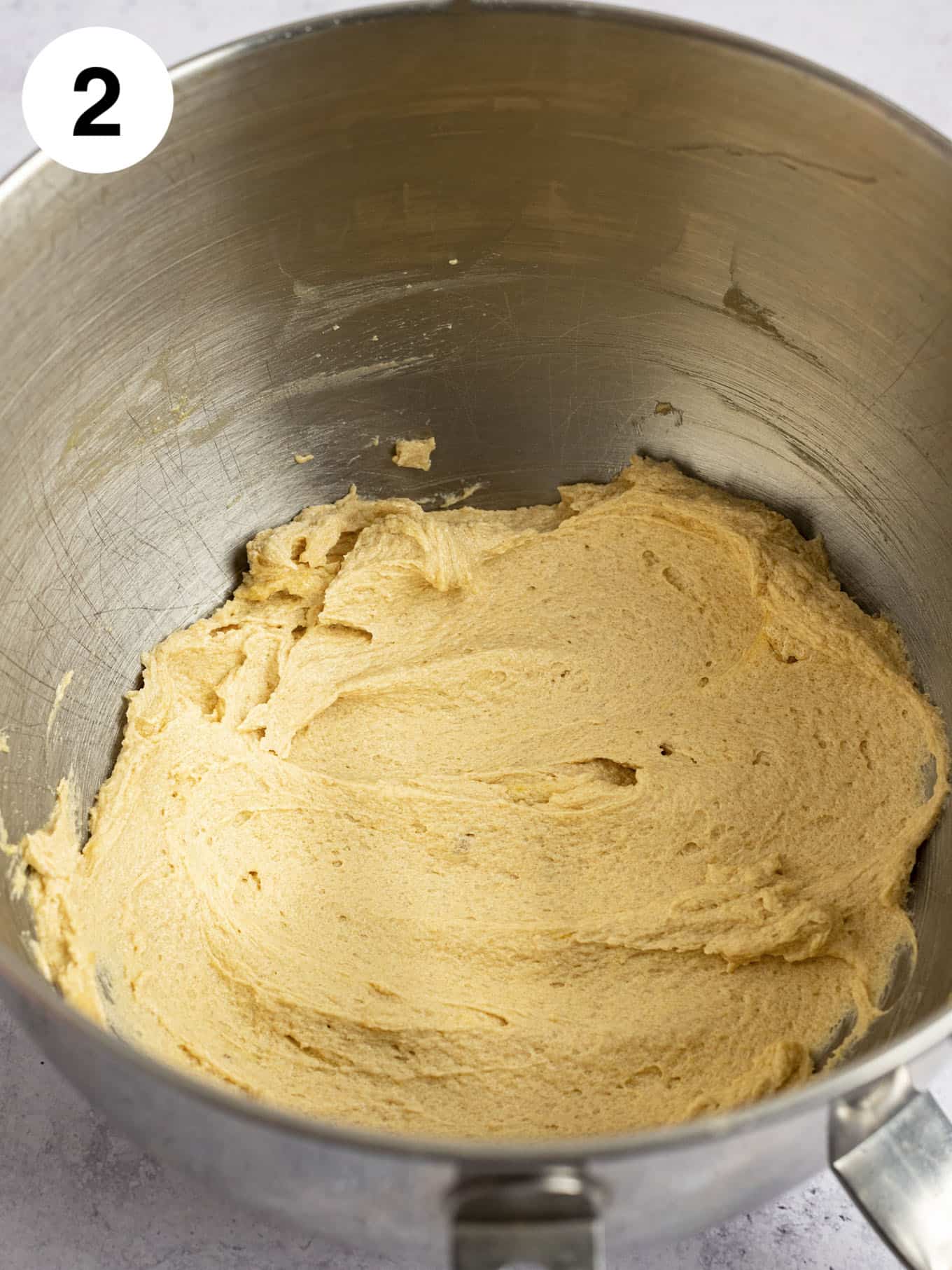 The wet ingredients mixed together in the bowl of a stand mixer.