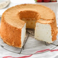 An angel food cake sitting on top of a wire rack.