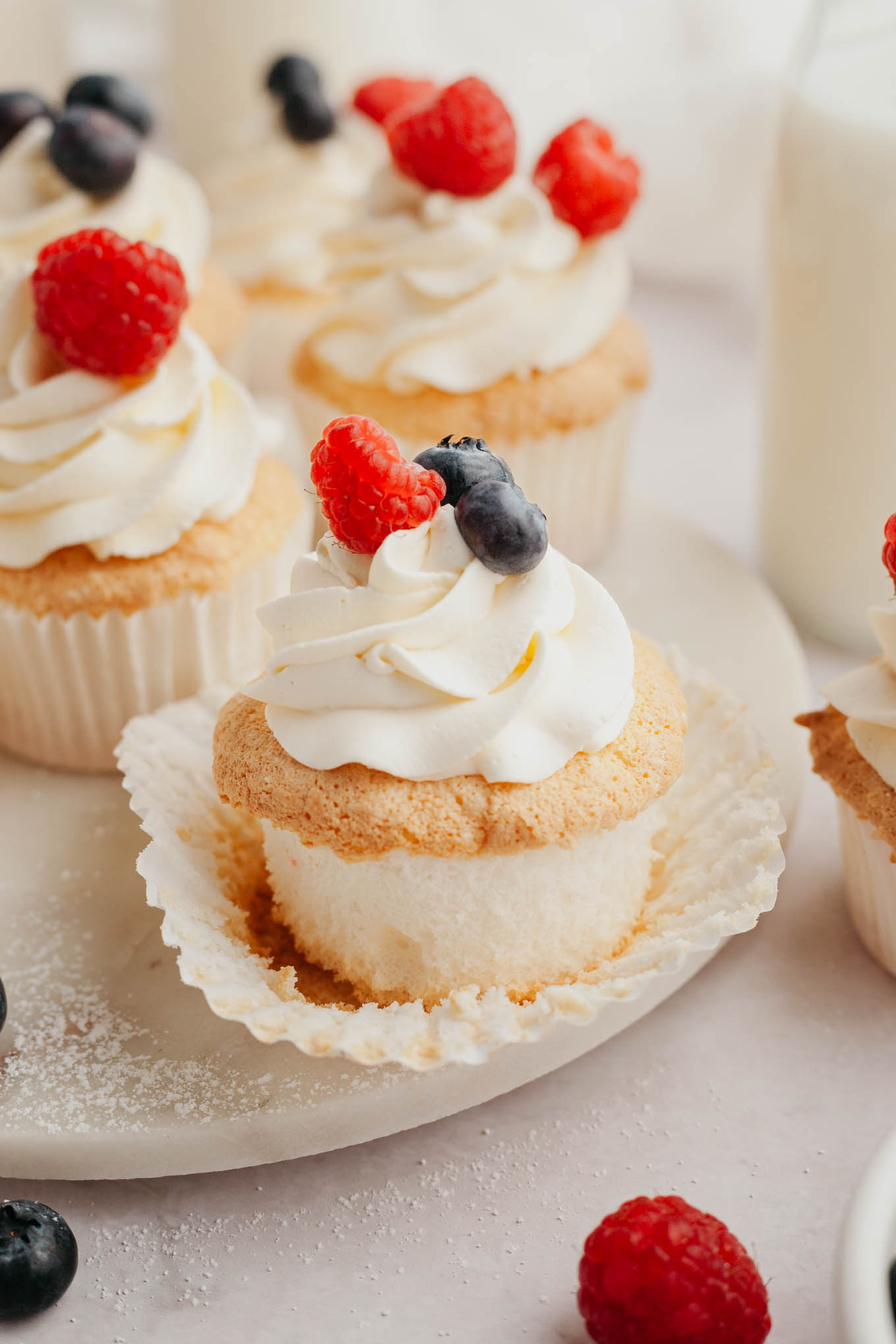 An angel food cupcake with the cupcake liner pulled down. 