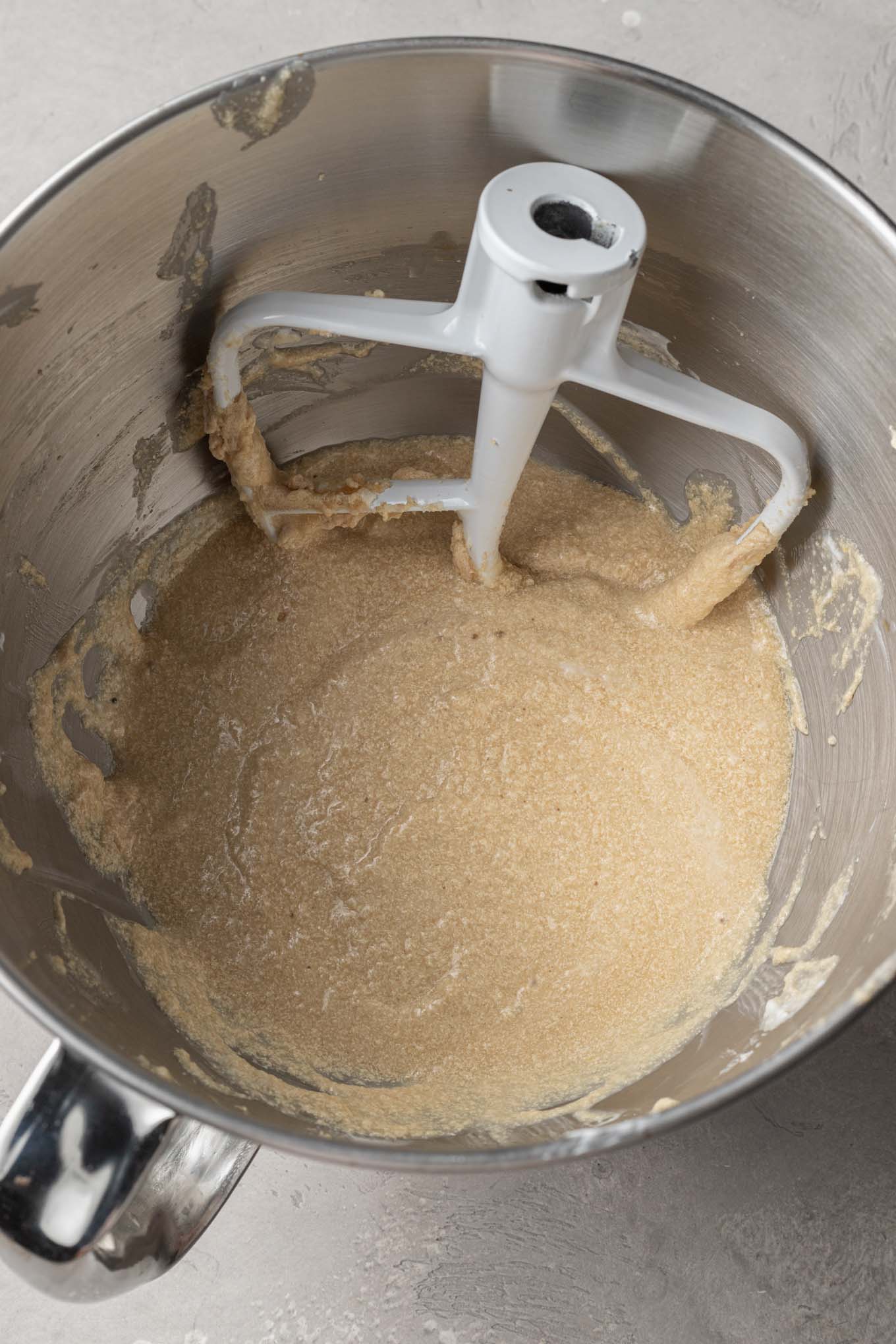 An overhead view of the wet ingredients for apple bread in a mixing bowl. 