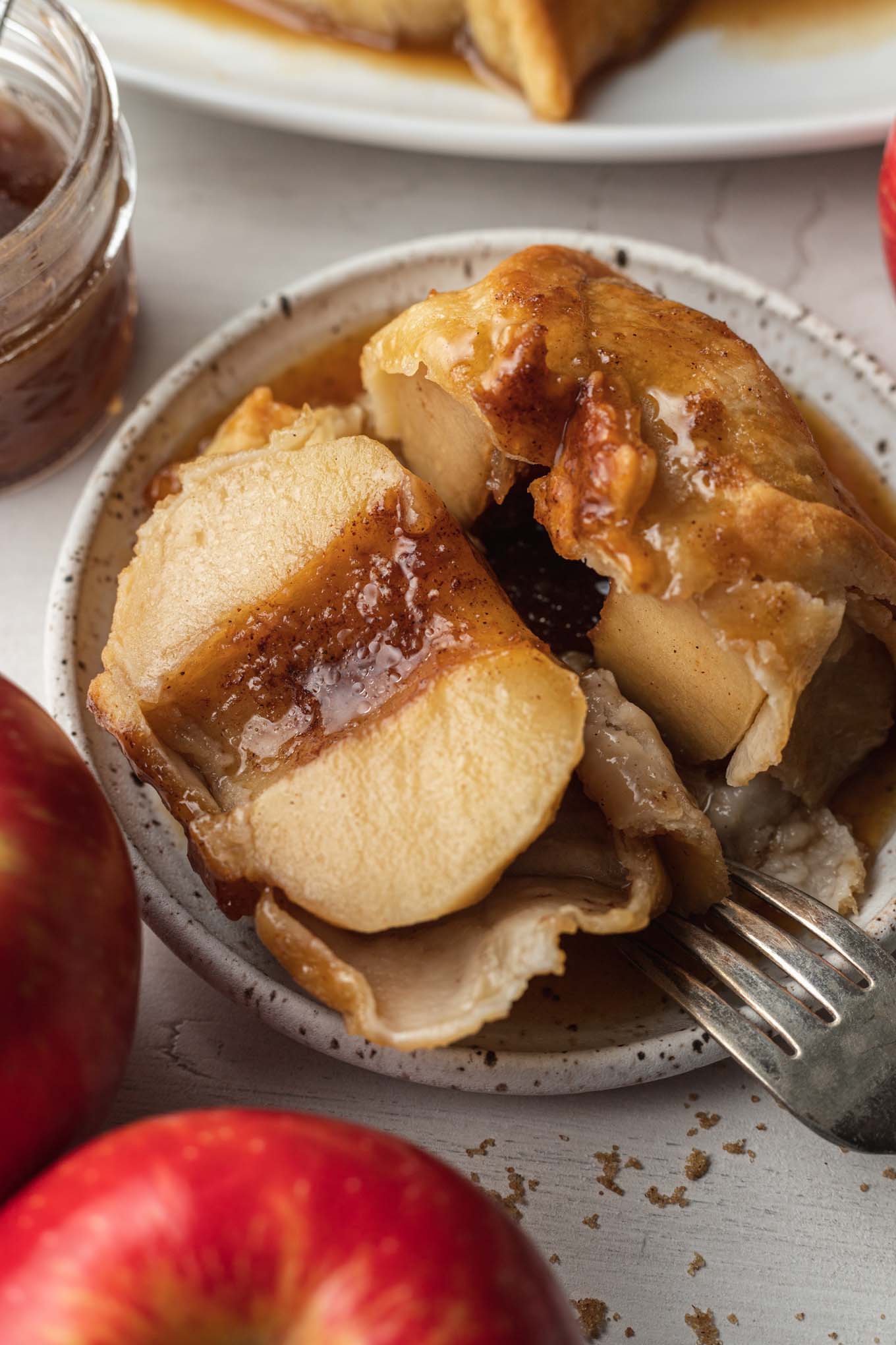 A dumping cut in half to show the apple inside. 