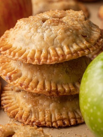 Three apple hand pies stacked on top of each other.