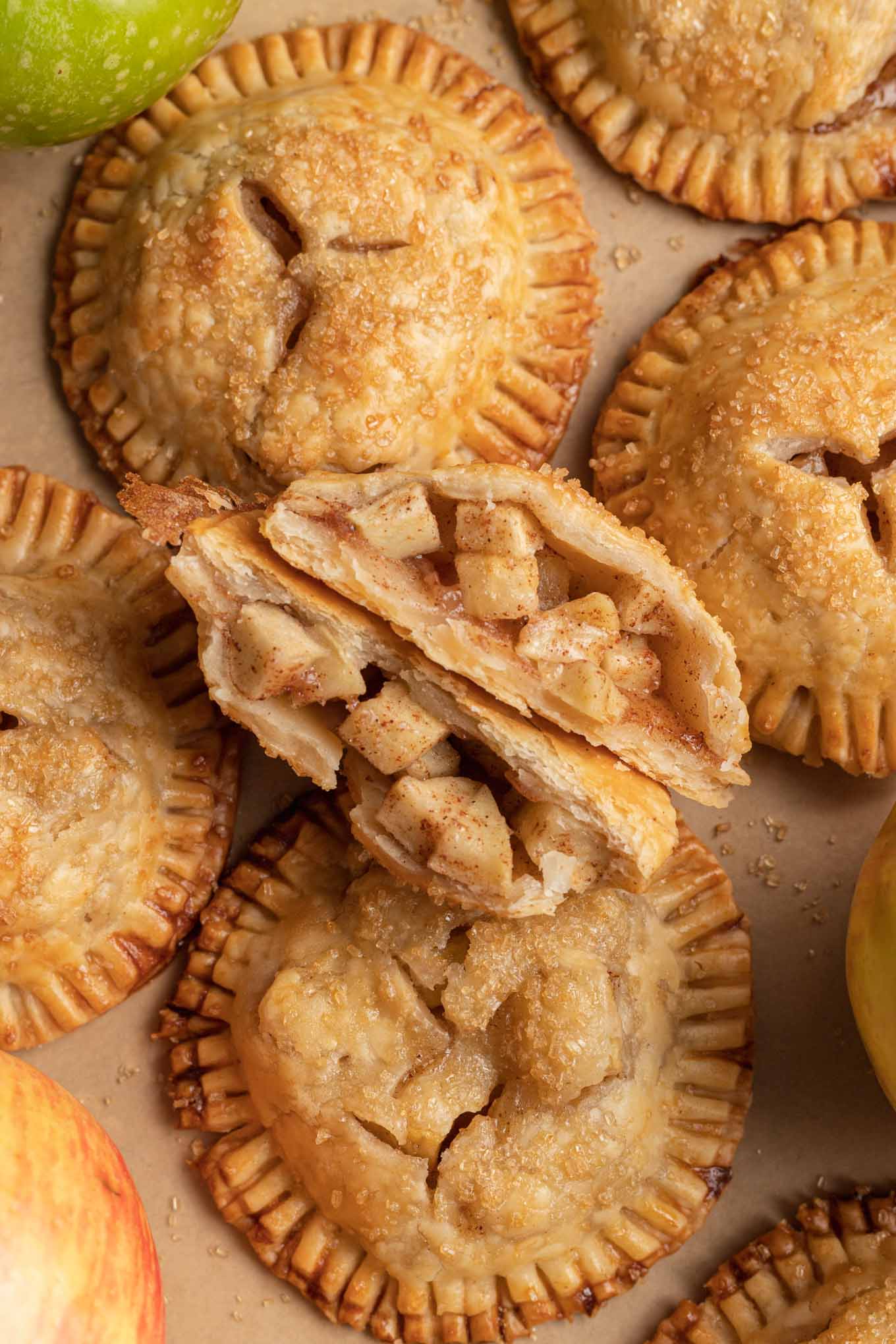 An overhead view of an apple hand pie cut in half and stood on its side to reveal the filling. 