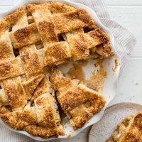 An overhead view of an apple pie with one piece removed.