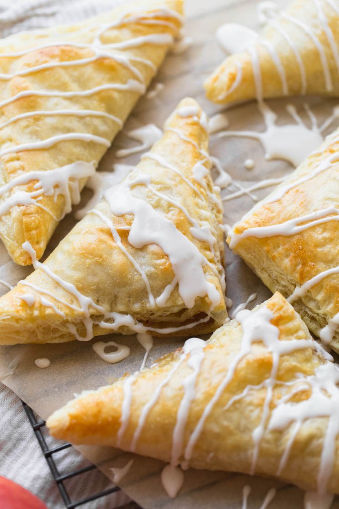 An up close image of apple turnovers topped with a maple cinnamon glaze.