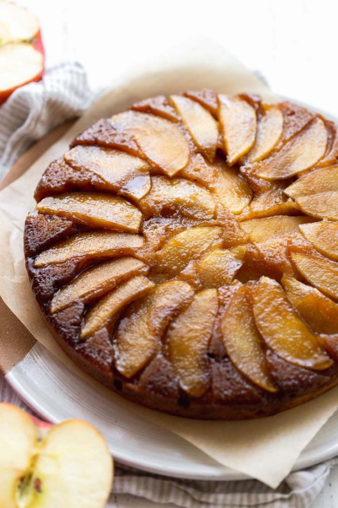 A close up image of an apple upside-down cake showing the caramelized apple topping.