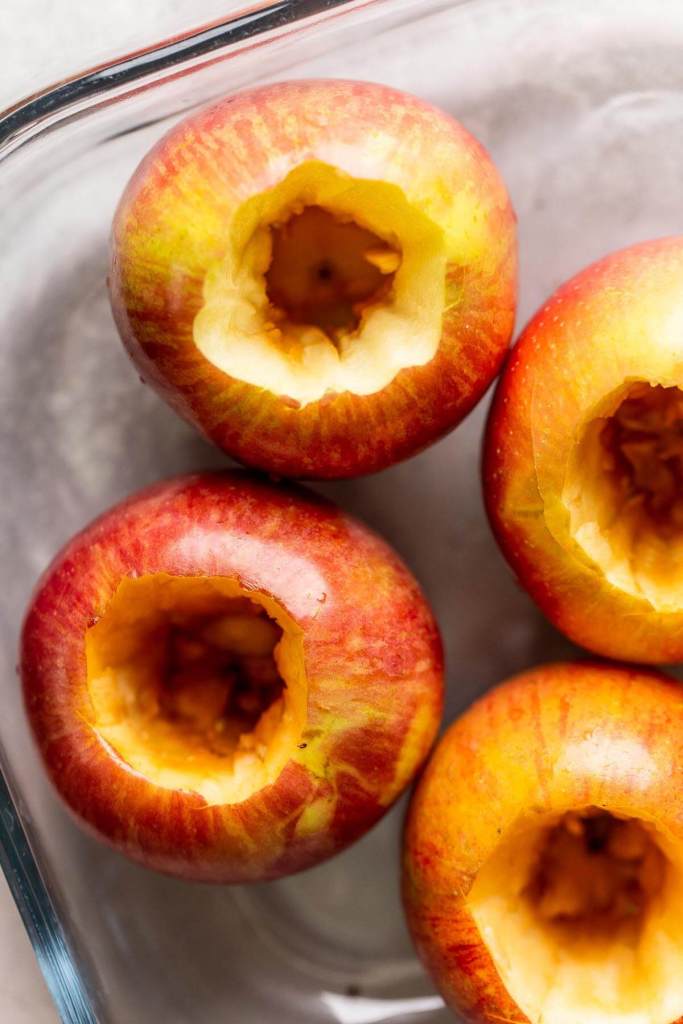 An overhead view of raw apples that have been cored. 