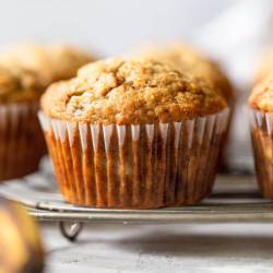 Banana muffins sitting on a round wire rack.