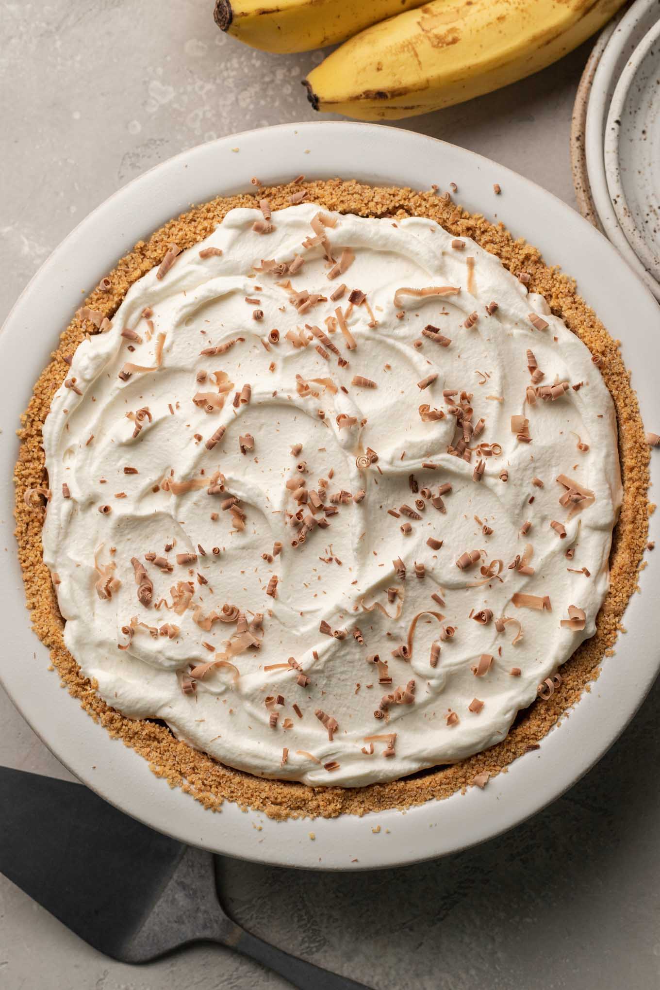 An overhead view of a finished banoffee pie topped with chocolate shavings.