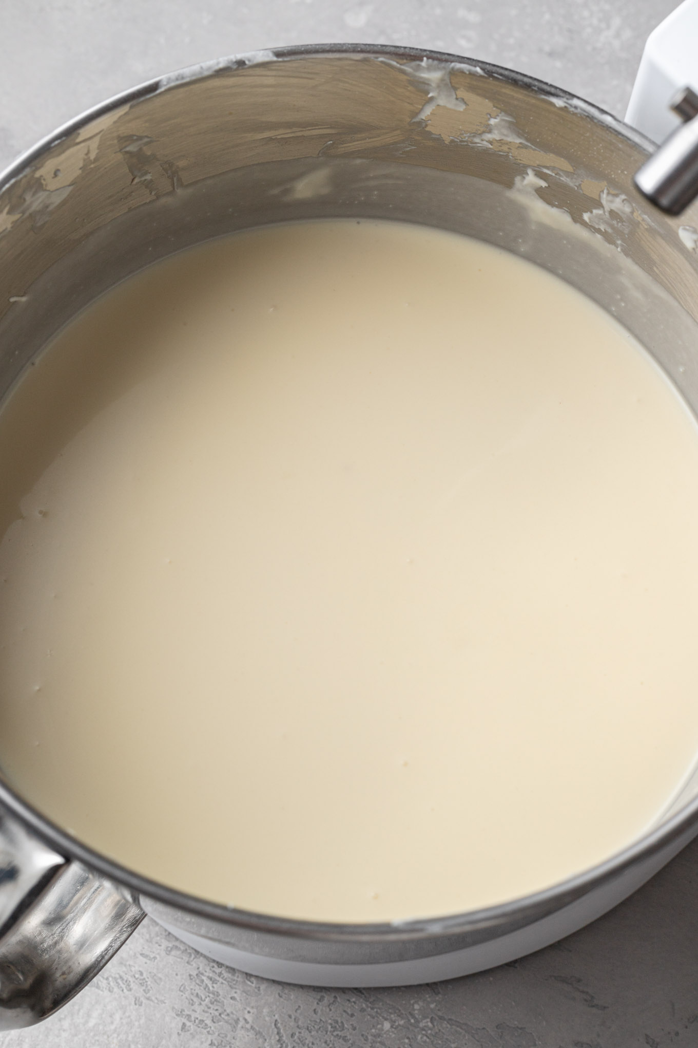 An overhead view of the finished Basque cheesecake filling in the bowl of a stand mixer.