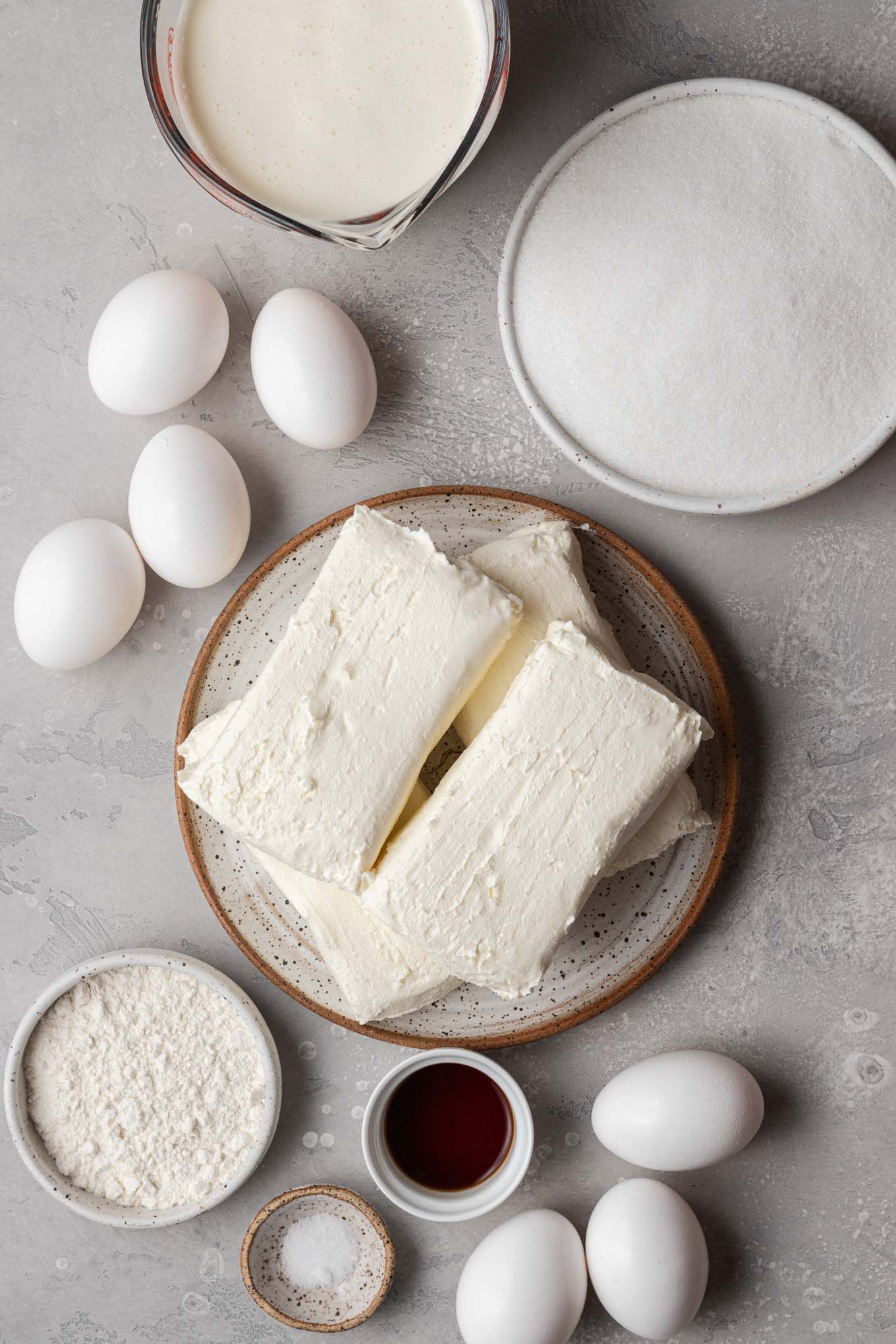 An overhead view of the ingredients needed to make Basque-style cheesecake. 