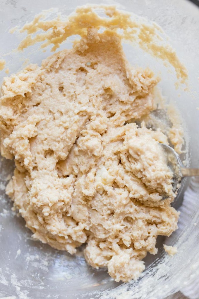 A glass bowl holding mixed up biscuit topping.