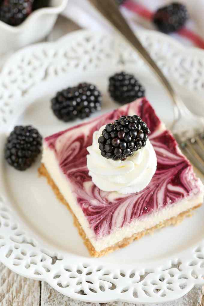 A homemade graham cracker crust topped with a smooth and creamy cheesecake filling and blackberry swirl. These Blackberry Swirl Cheesecake Bars make a gorgeous and delicious dessert!