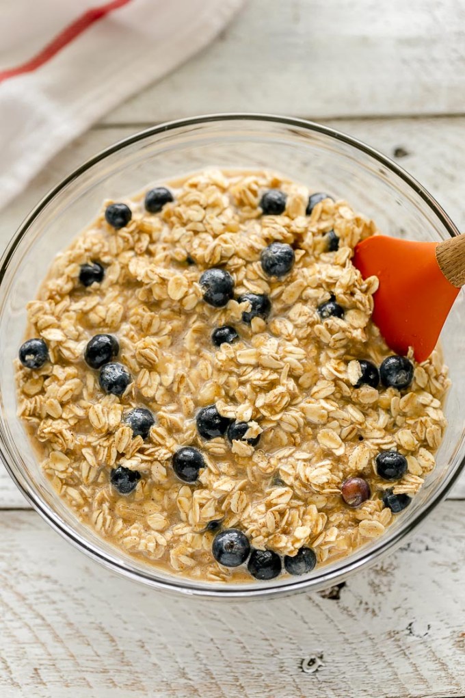 A glass bowl filled with the baked oatmeal mixture.