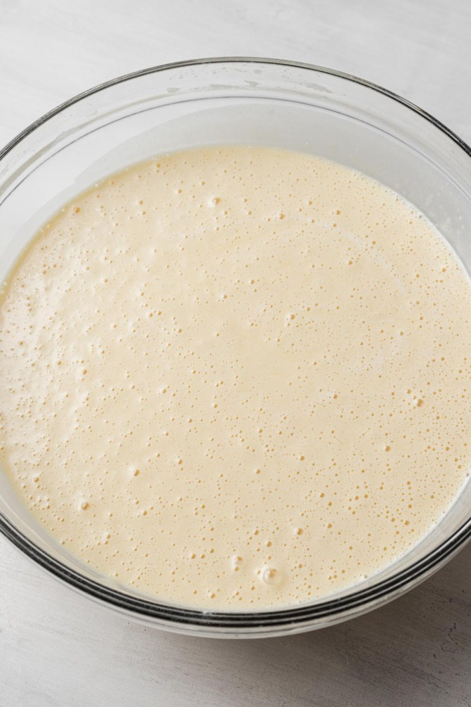 Sponge cake batter in a glass mixing bowl.