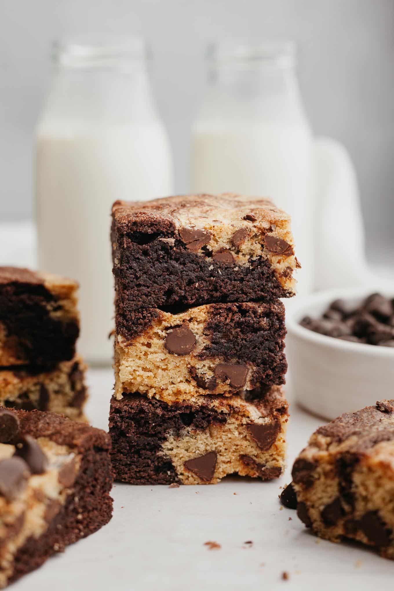 A stack of three brookies, with glass milk jugs in background. 