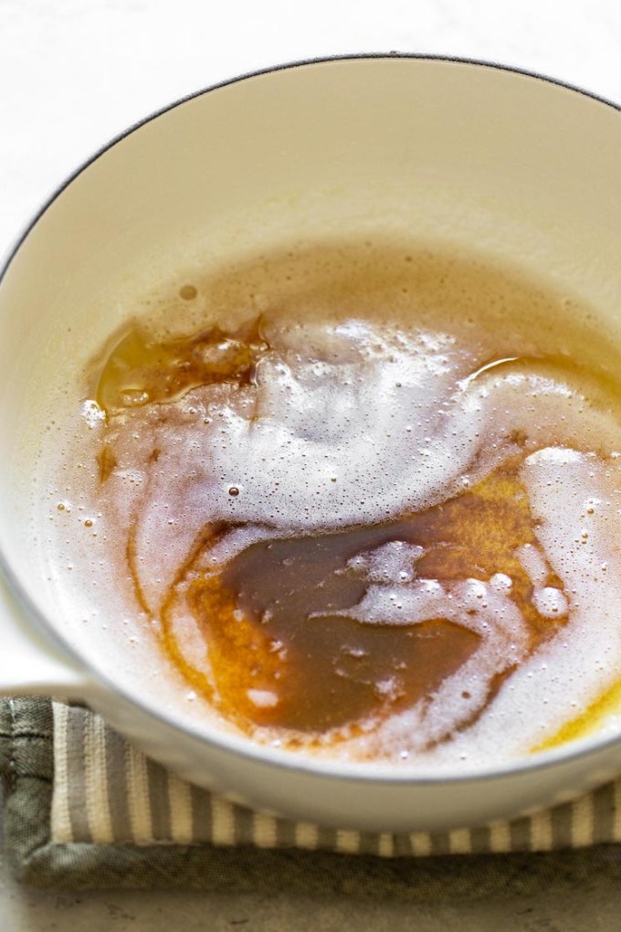 A white sauce pan holding brown butter.