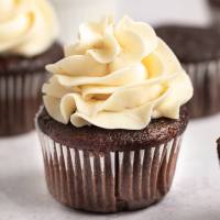 A chocolate cupcake topped with brown butter frosting.