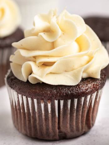 A chocolate cupcake topped with brown butter frosting.