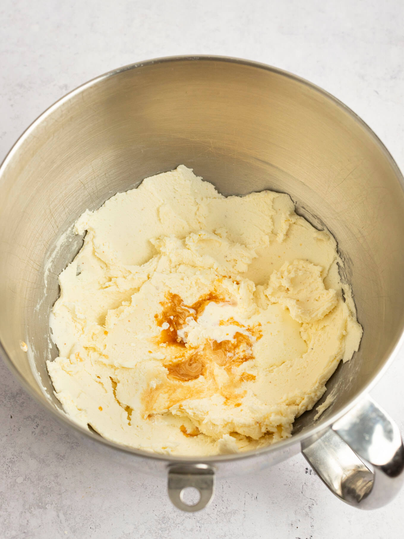 Heavy cream, vanilla extract, and salt added on top of the creamed butter and powdered sugar.