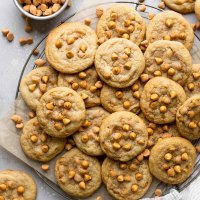 An overhead view of butterscotch cookies piled on a wire cooling rack.