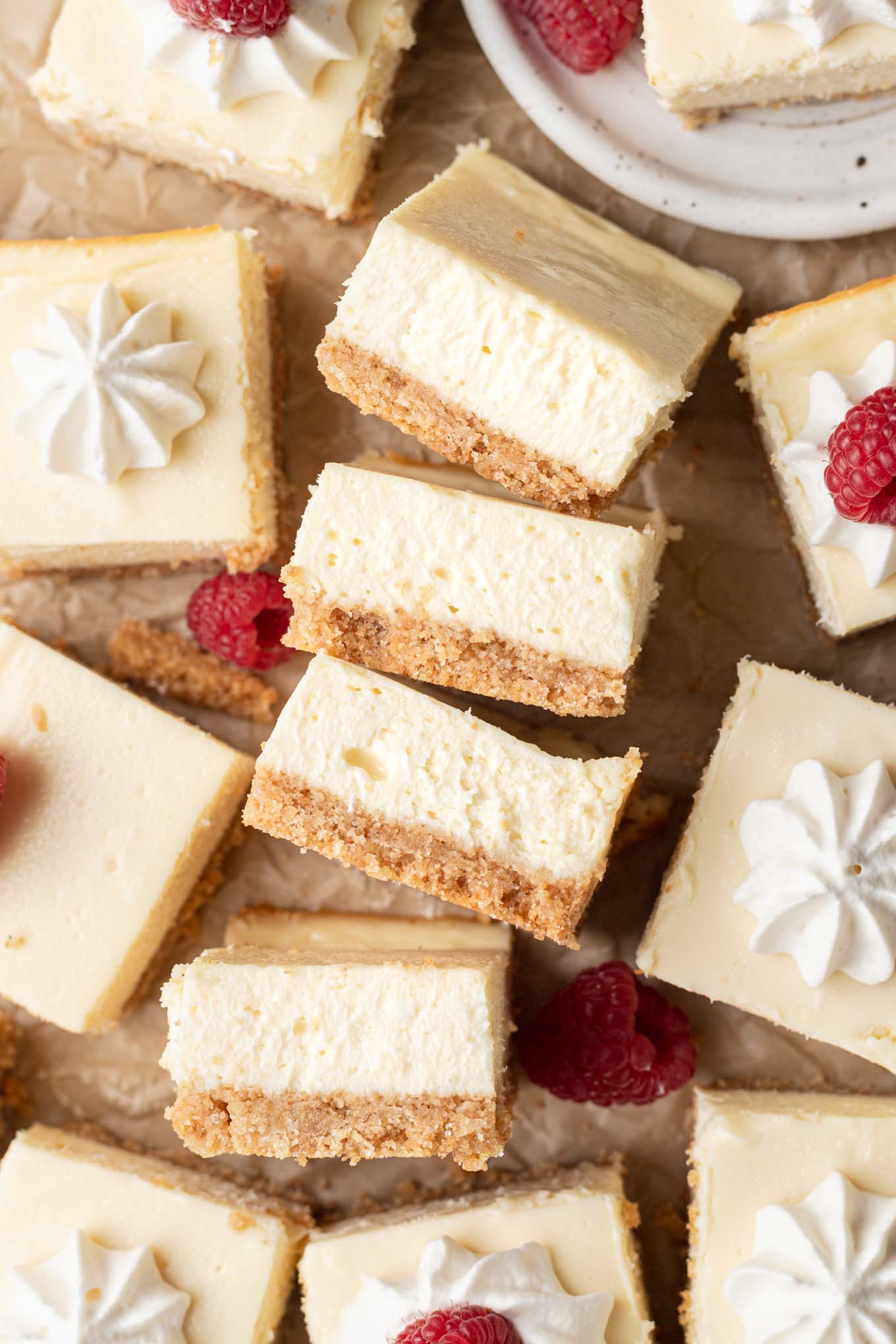 An overhead view of four cheesecake bars turned on their sides and lined up. 