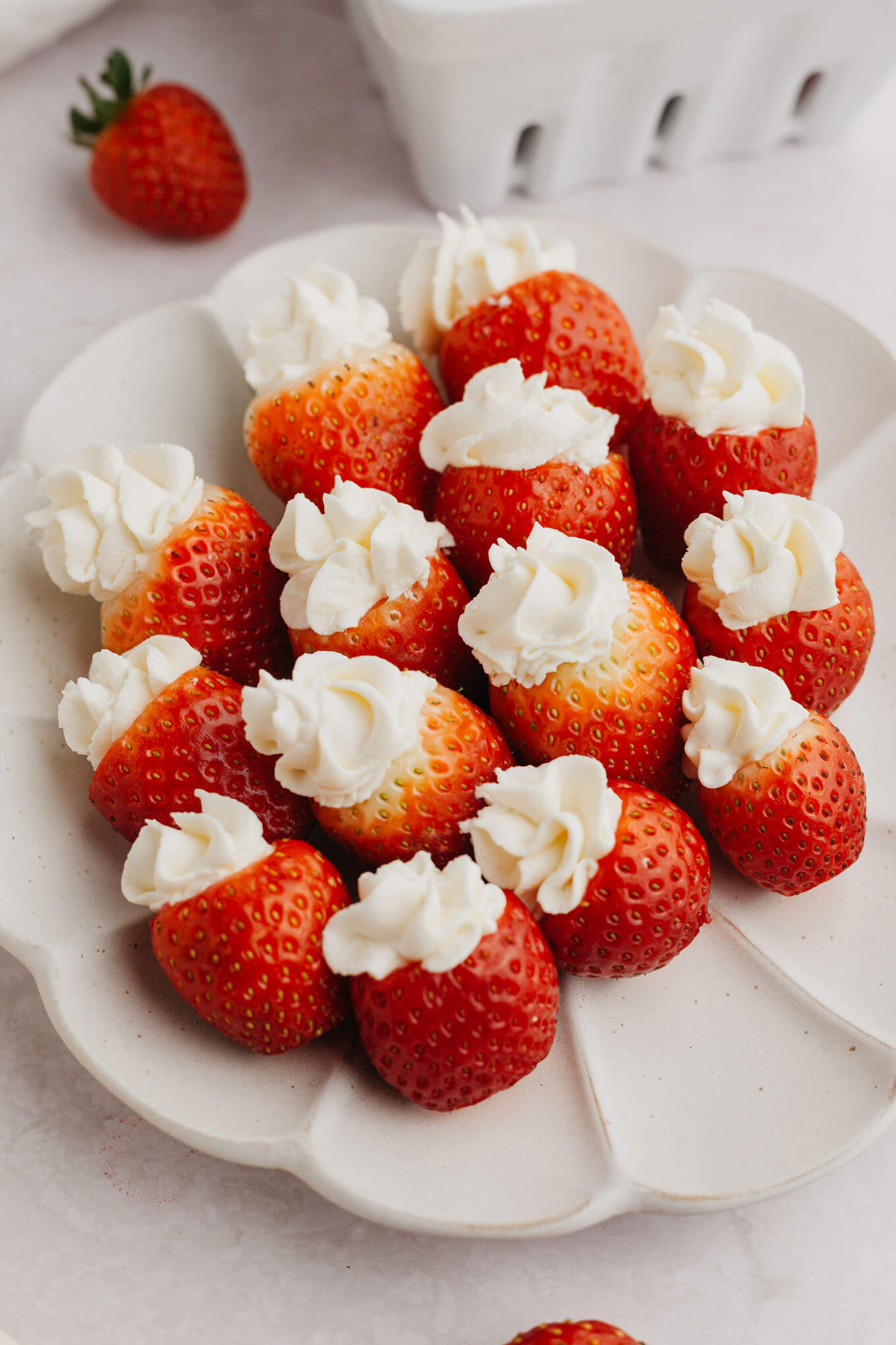 A plate of cheesecake stuffed strawberries. 