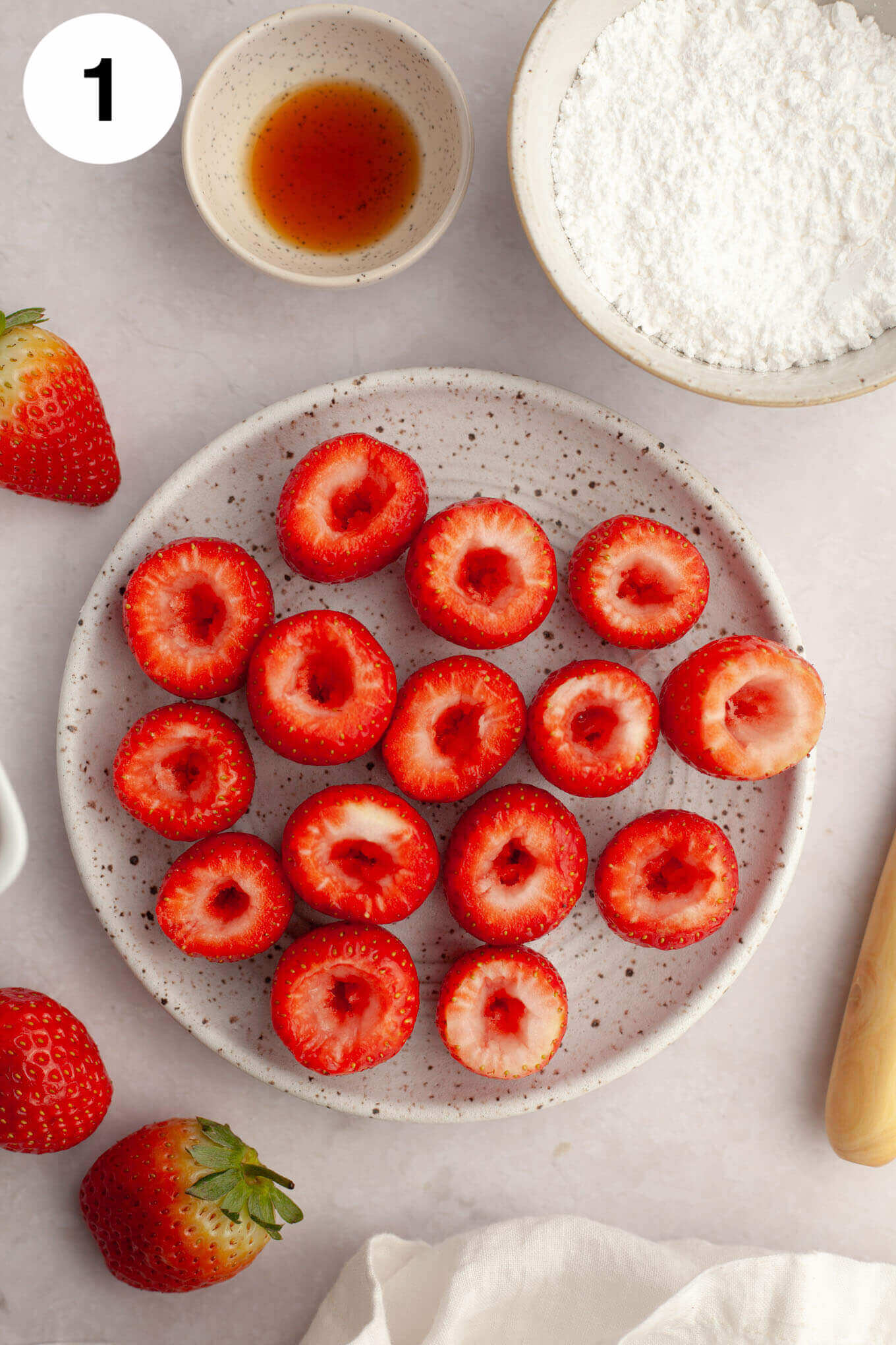 A process shot showing strawberries that have been hollowed out. 