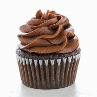 A single chocolate cupcake topped with a swirl of chocolate buttercream frosting.