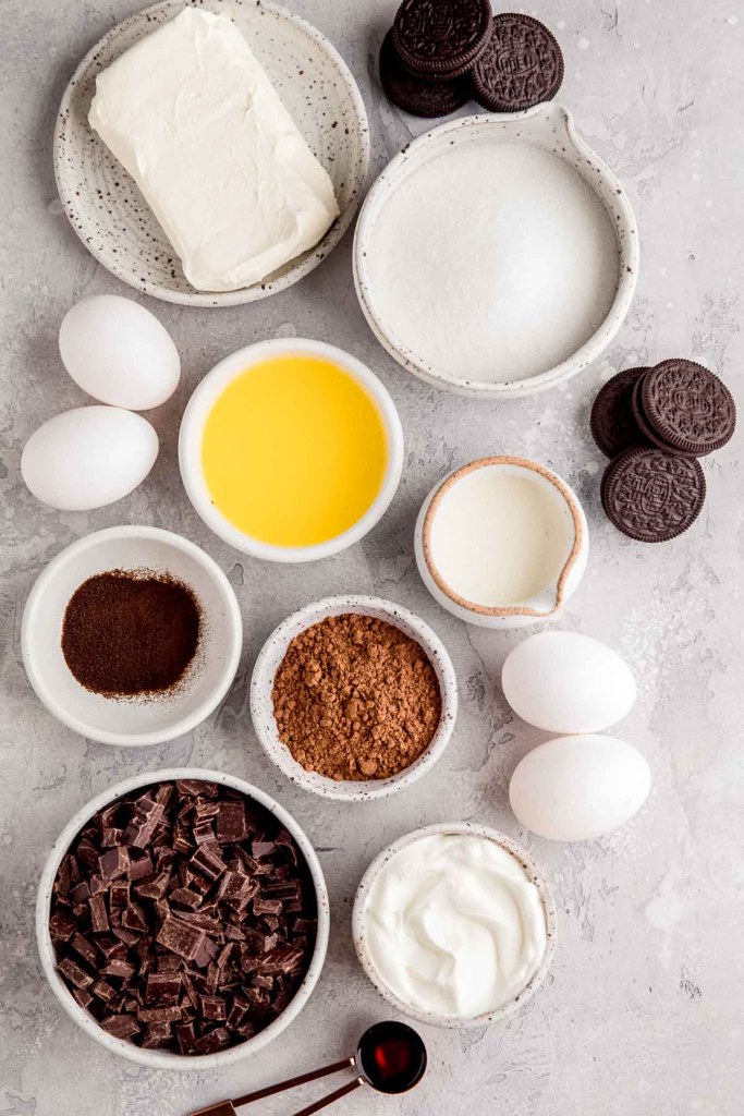 An overhead view of the ingredients needed to make a chocolate cheesecake. 