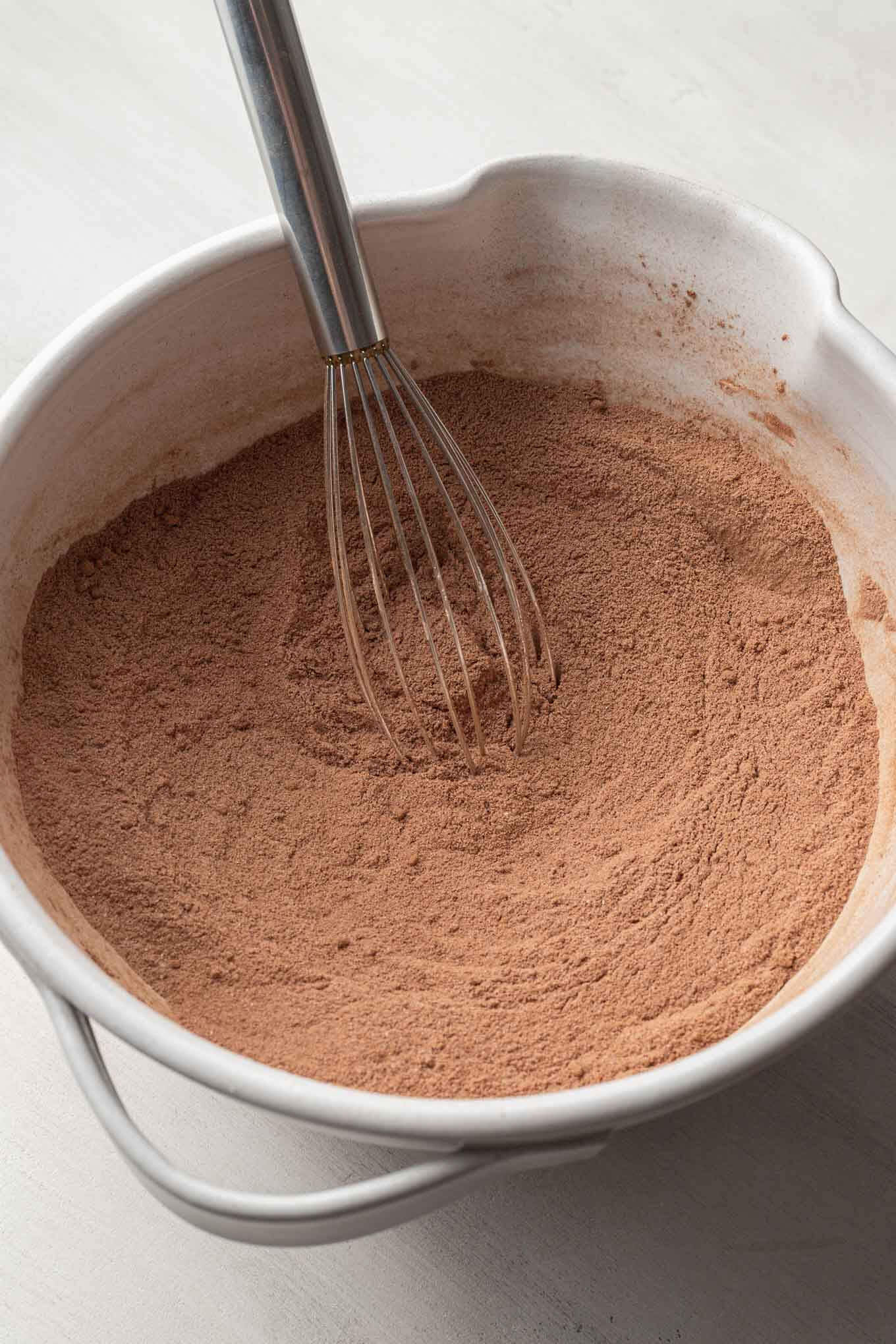 A cocoa powder-flour mixture in a white mixing bowl.