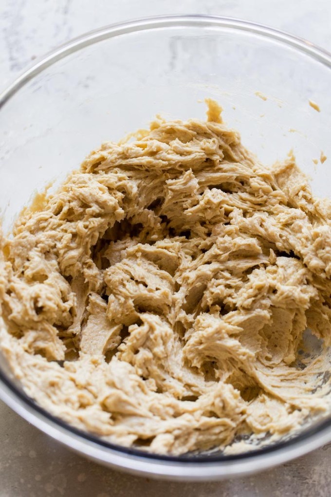 The wet ingredients for cookies mixed up in a glass bowl.