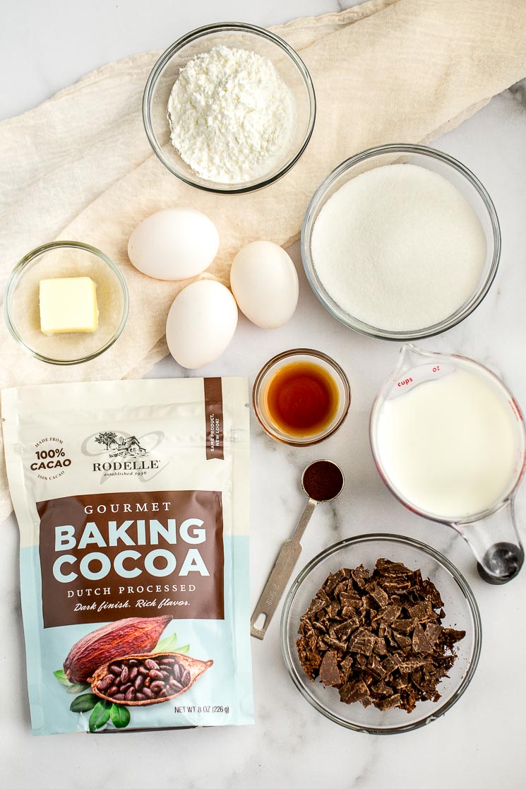 The ingredients for the chocolate cream pie filling sitting on a marble surface.