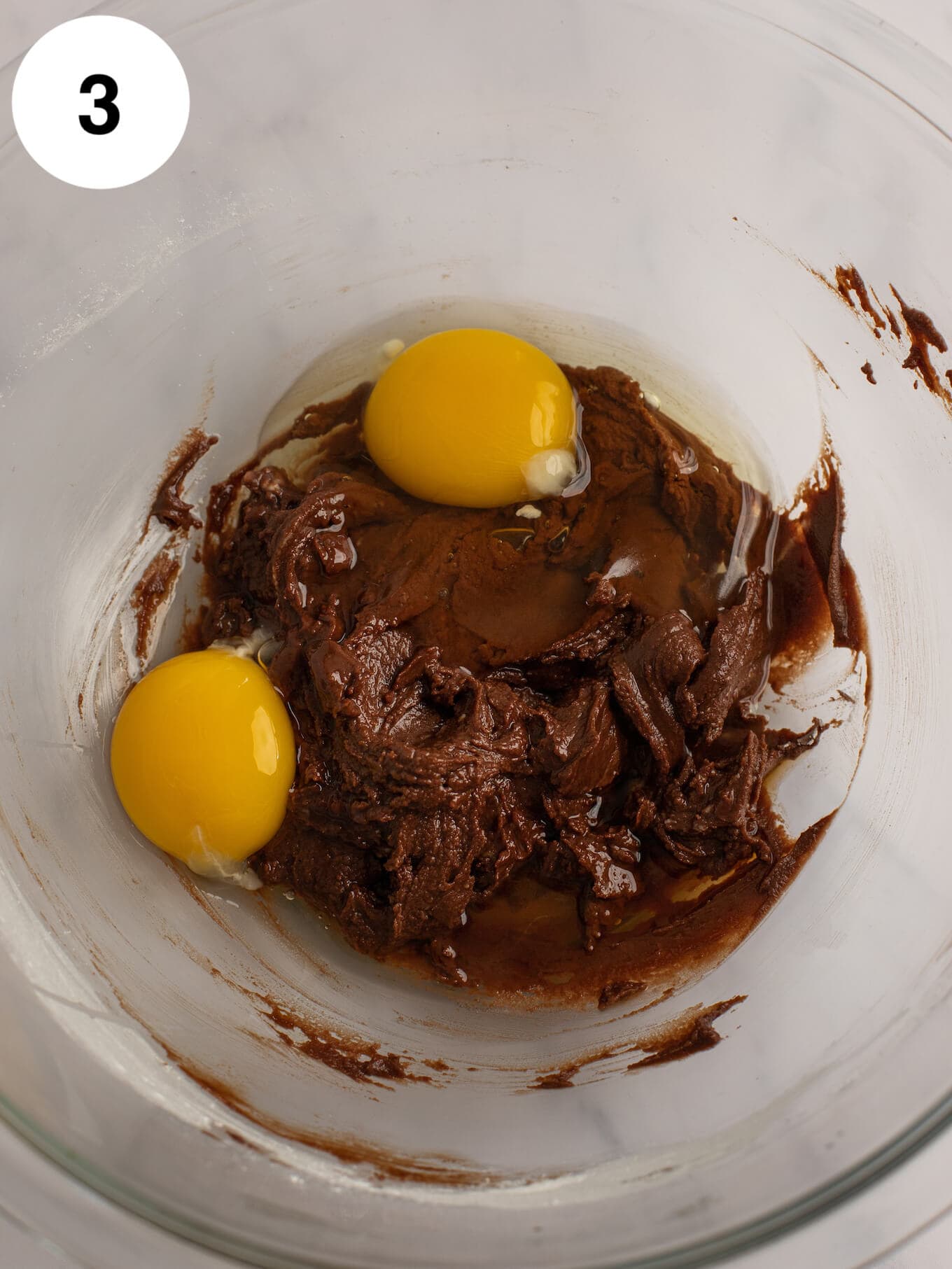 The batter mixed together with an egg and egg yolk on top.