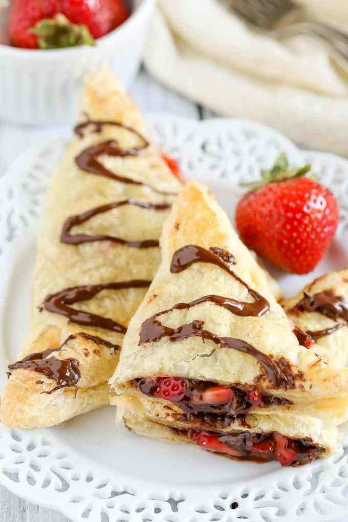 Puff pastry stuffed with chocolate, Nutella, and fresh strawberries. These Chocolate Strawberry Nutella Turnovers make one delicious and decadent dessert!