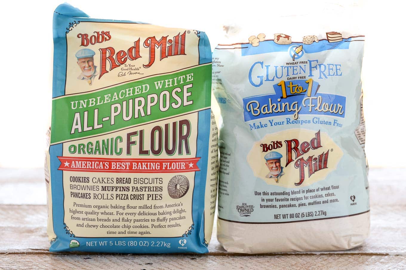 A bag of Bob's Red Mill all-purpose flour next to a bag of gluten-free 1:1 flour. 