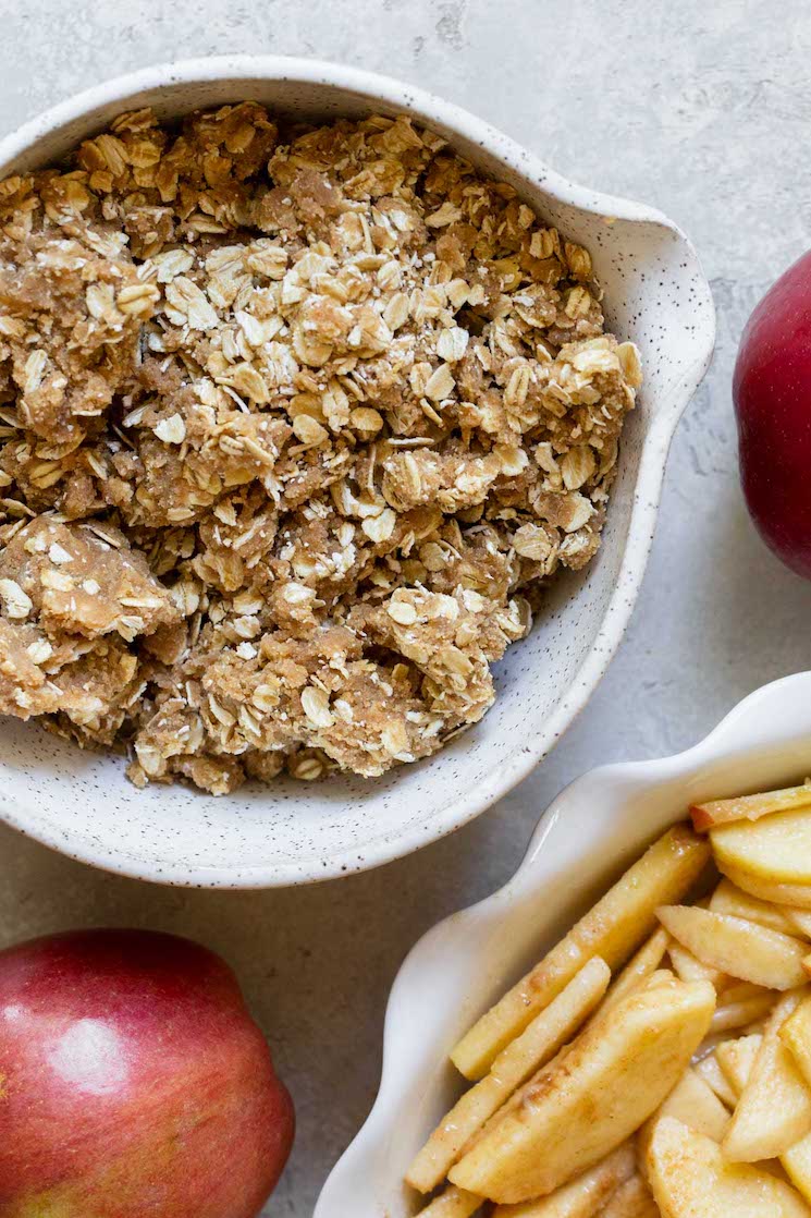 The oat topping mixed together in a small bowl ready to be put on the apples.