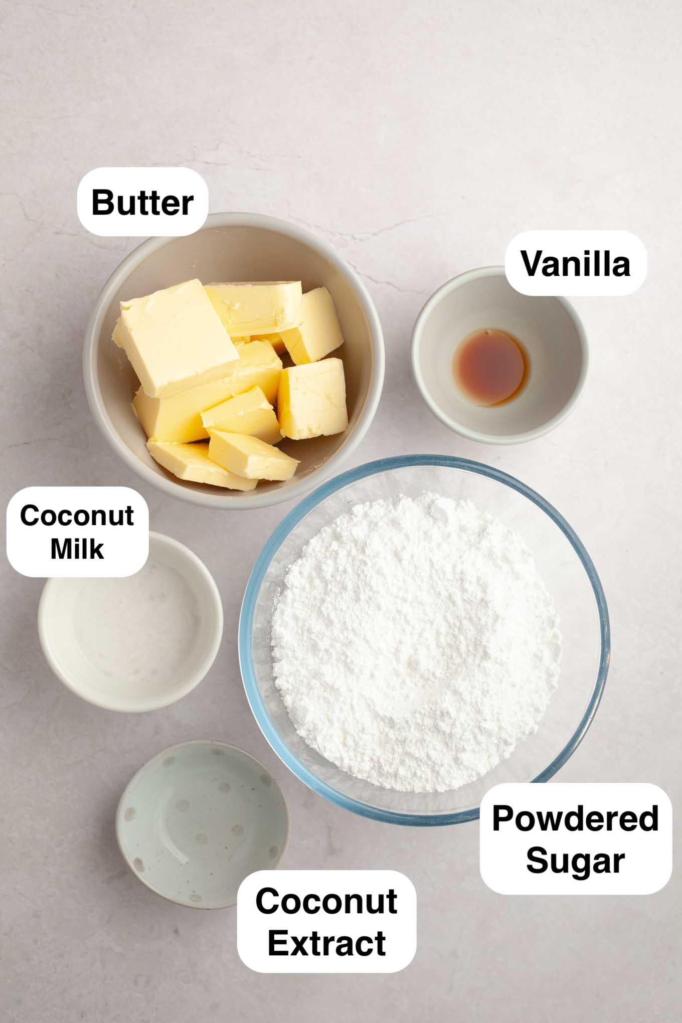 An overhead view of the various ingredients needed to make coconut frosting.