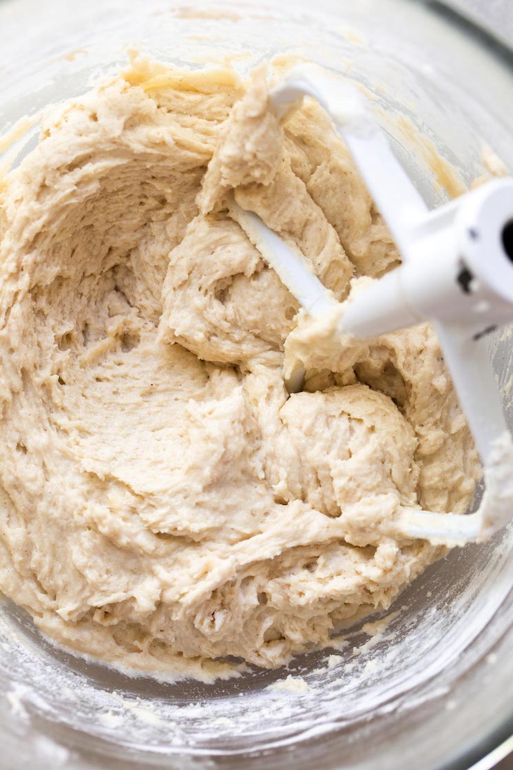 A glass mixing bowl filled with cake batter.