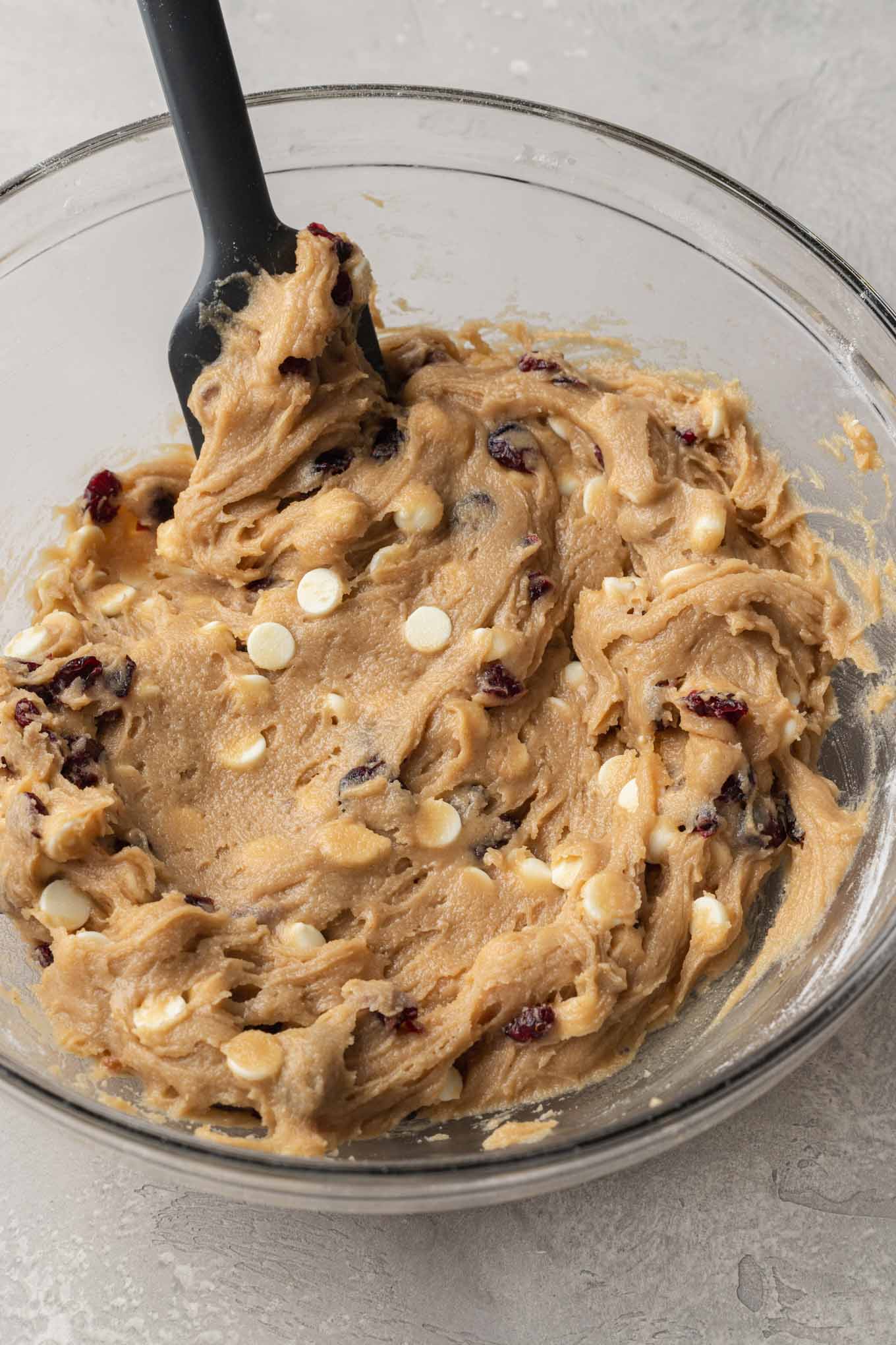 An overhead view of cranberry bliss bar batter in a mixing bowl. 