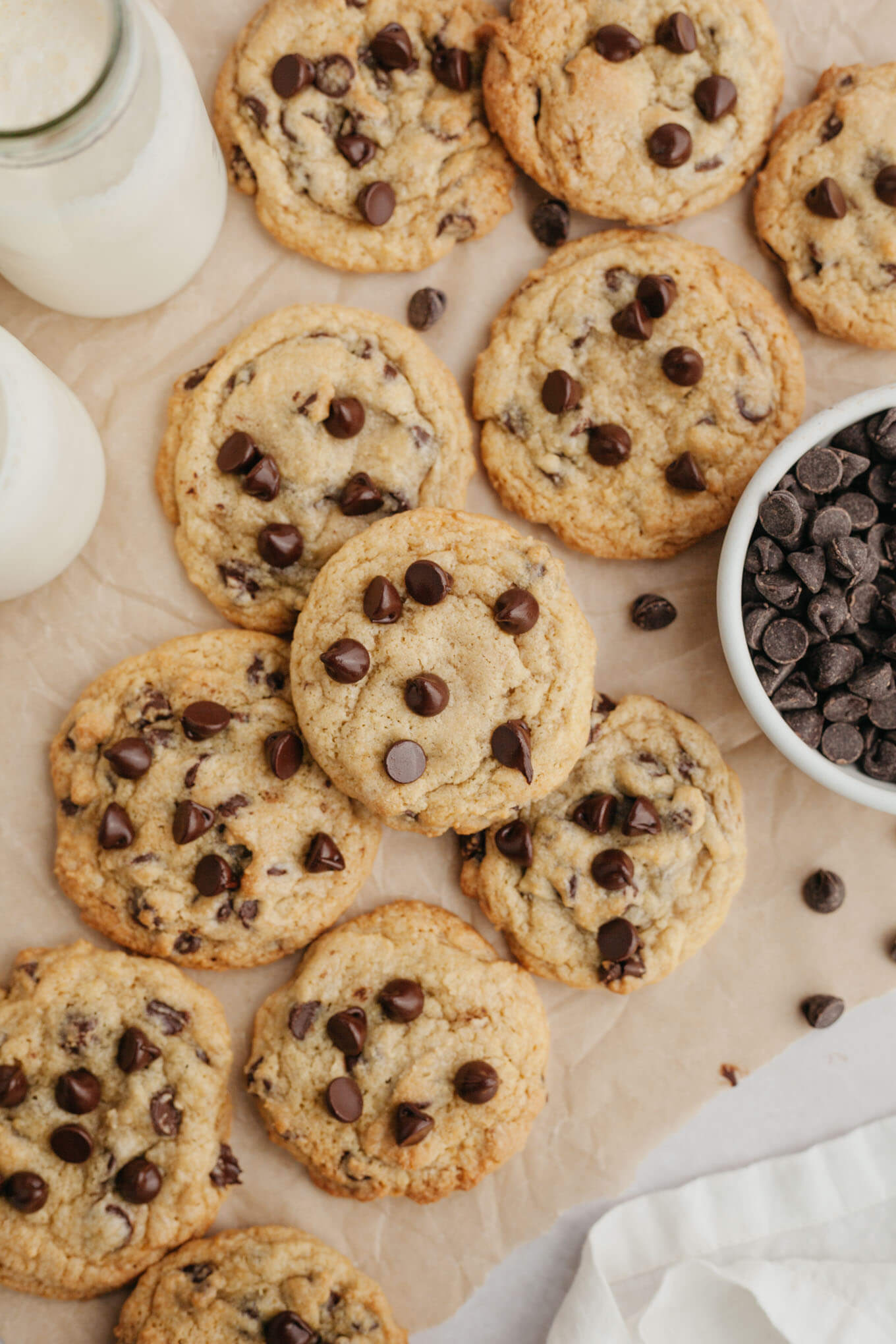 An overhead view of chocolate chip cream cheese cookies on parchment paper. 