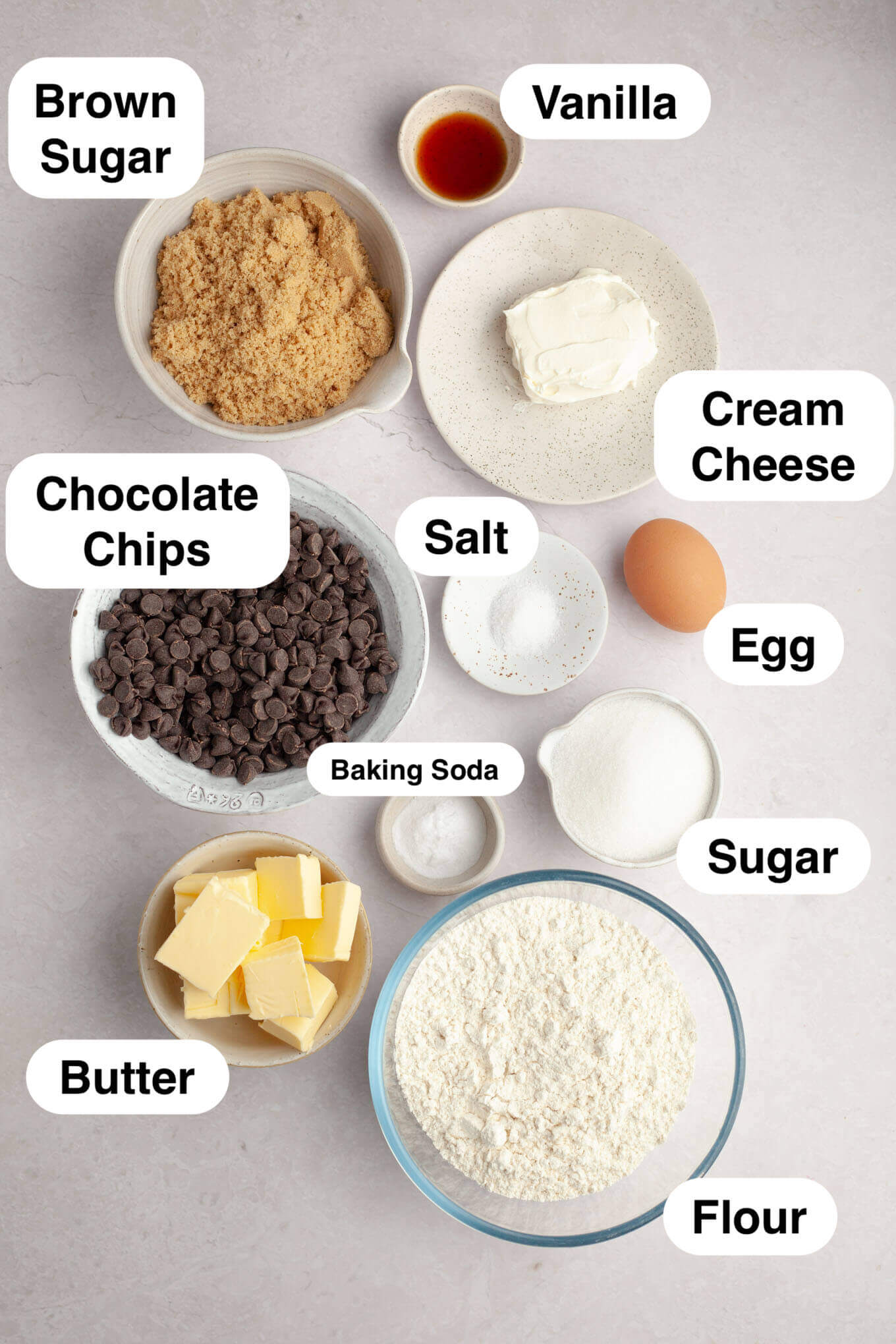 An overhead view of the ingredients needed to make chocolate chip cookies with cream cheese. 