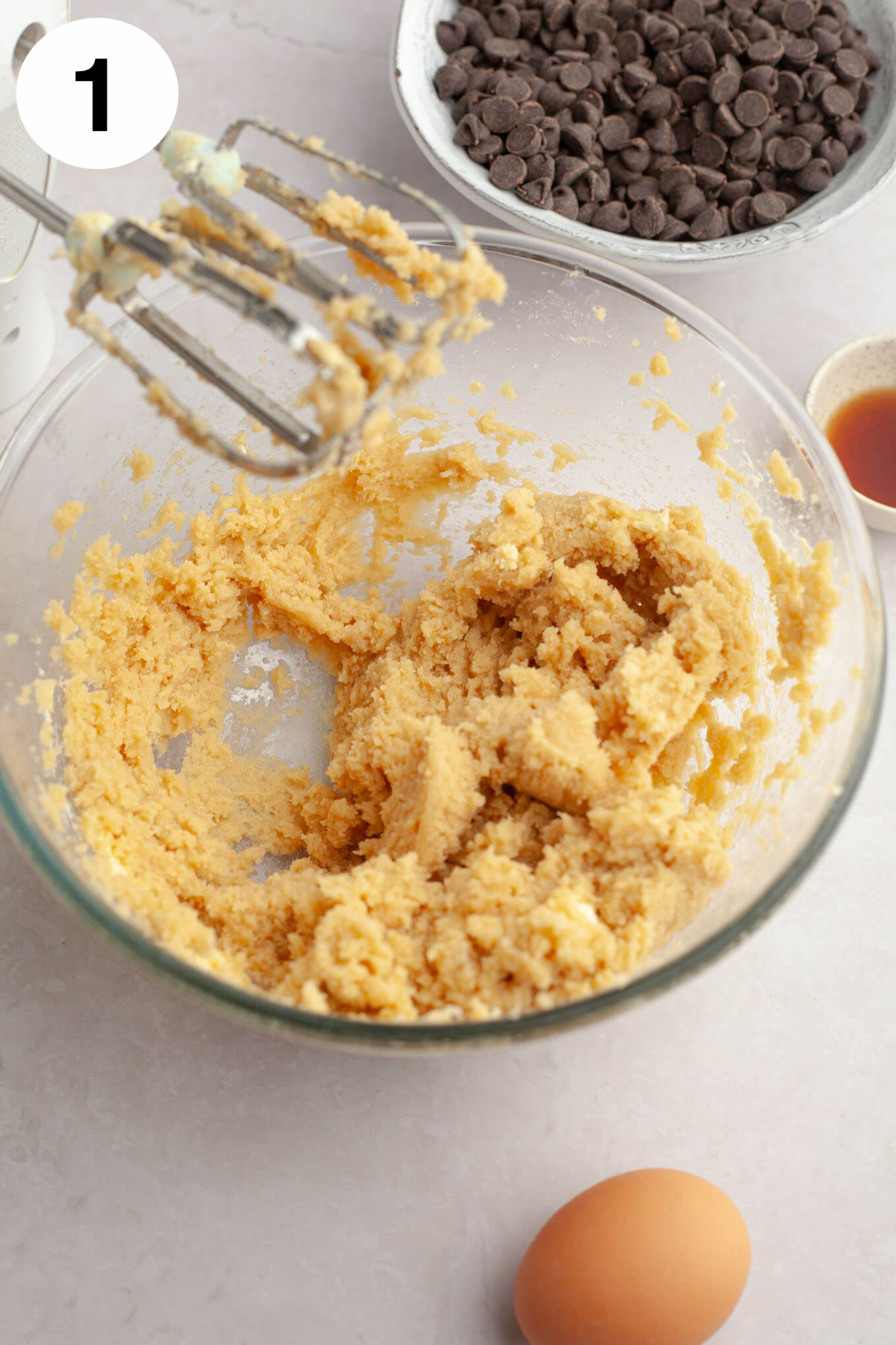 A glass mixing bowl with butter, cream cheese, brown sugar, and granulated sugar mixed together.