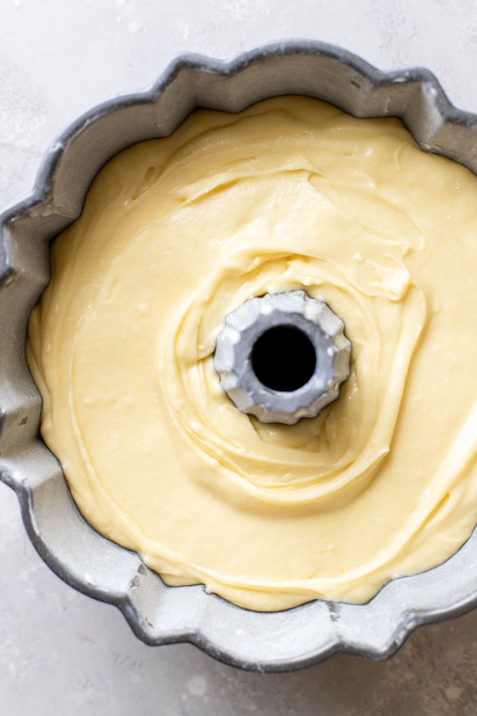 The pound cake batter poured into a bundt pan.