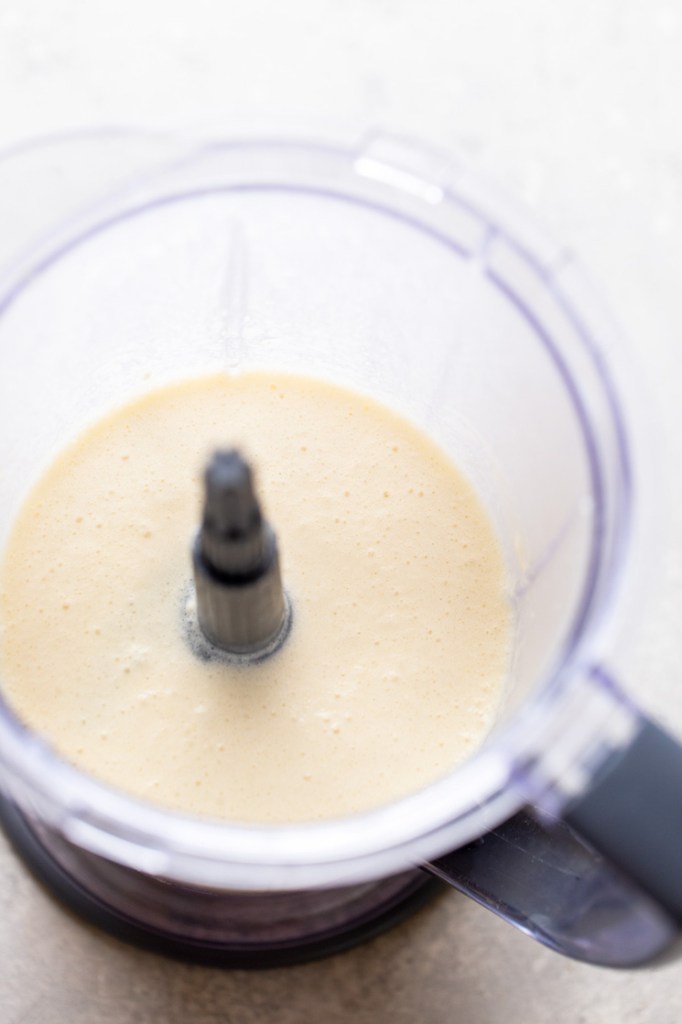 Overhead view of crepe batter in a blender. 