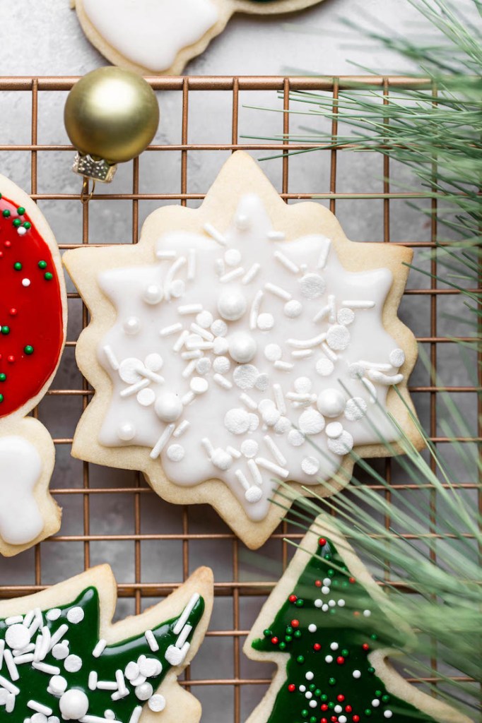 A close up of decorated cookies on a cooling rack.