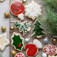 A cooling rack filled with decorated cut out sugar cookies.