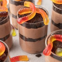 Several dirt cups topped with gummy worms.