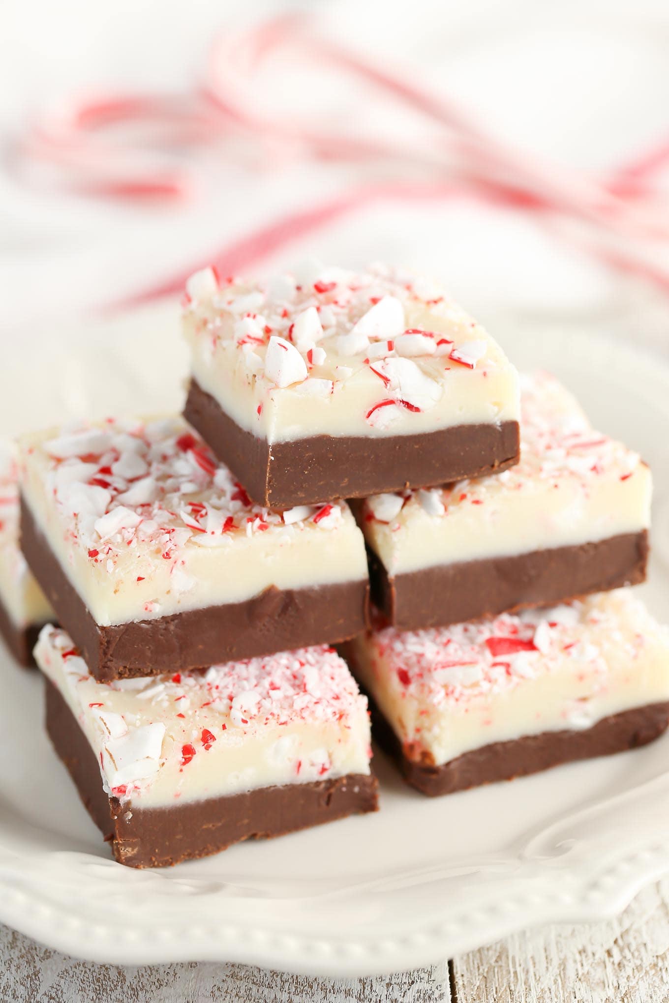 Stack of peppermint fudge on a white plate. 